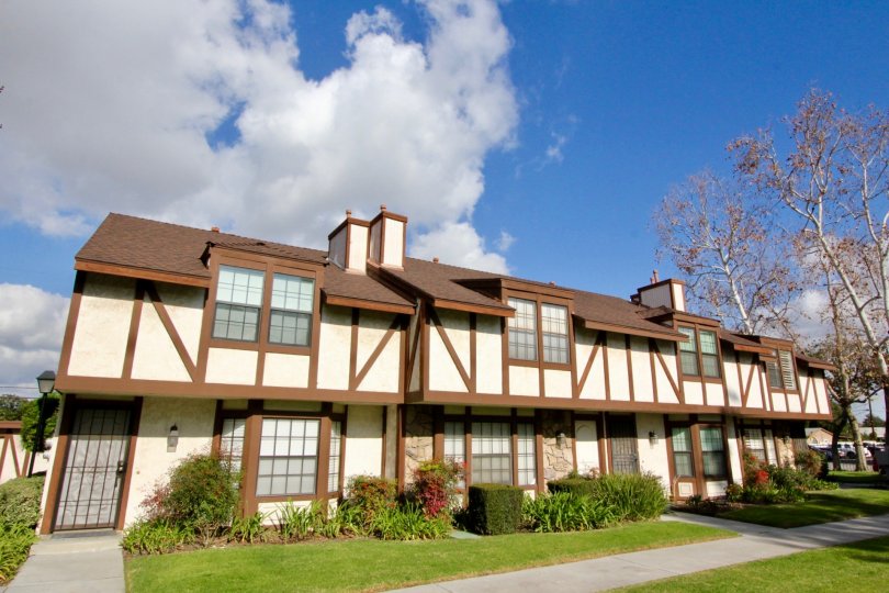 white townhomes that have tudor wood work and plants in the front in chelsea park estates community in fullerton, ca..