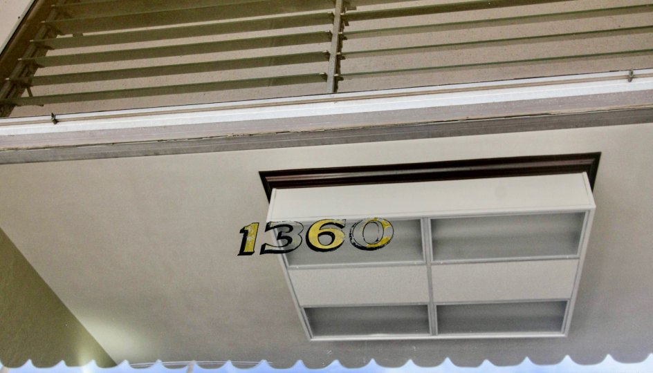 Glass window in Shadow Lane has painted a number 1360 at Fullerton city