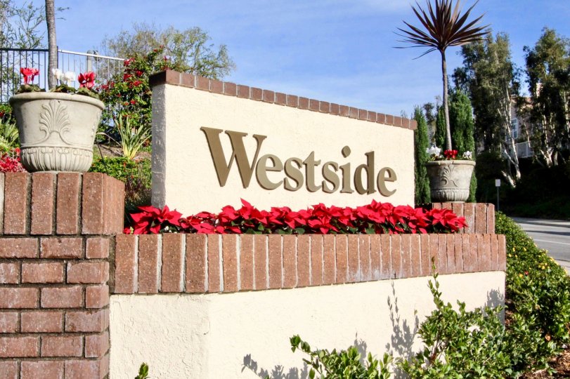 A tan and golden sign for the entrance to the community Westside.