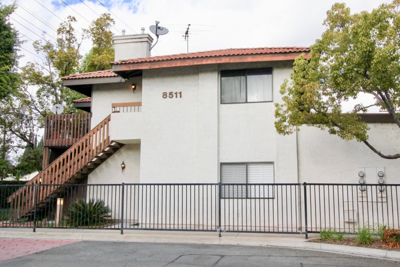compound gate view of the building no 8511 having trees and plants around in Meadow Brook Village