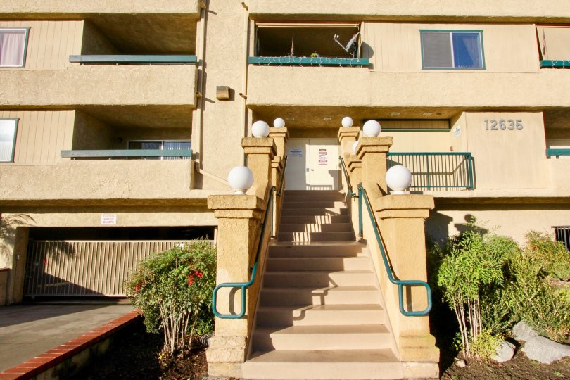 a sunny day in the grove with house that has stepless in center and left side on parking door closed