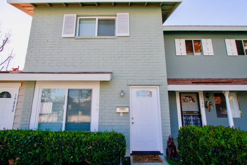 Huntington Continental Huntington Beach California building light gray color paint front glass window attached white color door attached