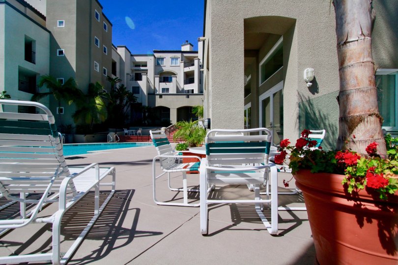 Beautiful sitting place near swimming pool between villas having flower garden in Pier Colony of Huntington Beach