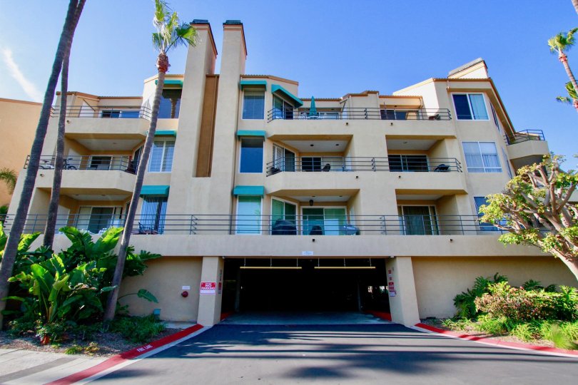 Beautiful entrance view of an apartment with trees around in Portofino Cove of Huntington Beach