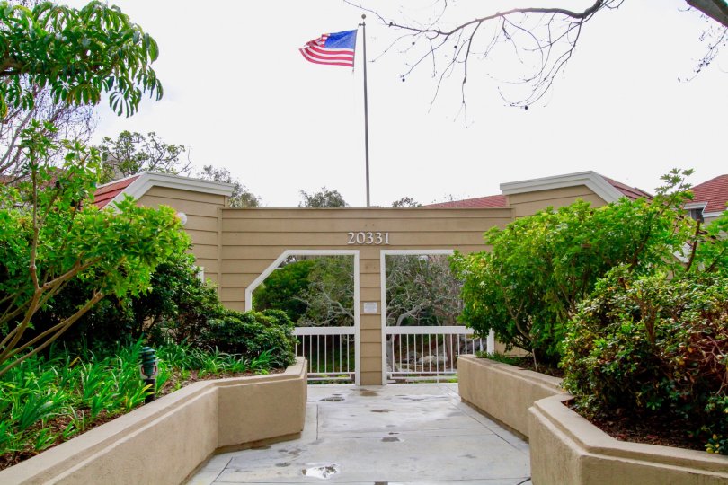Entrance to Seabridge Villas with a gate and American flag.