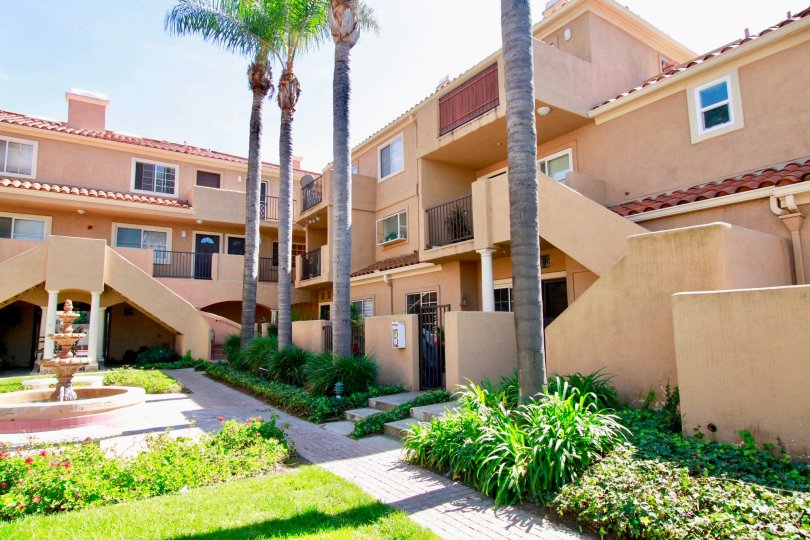 Villas Del Mar apartments with a fence and staircases on a sunny day.