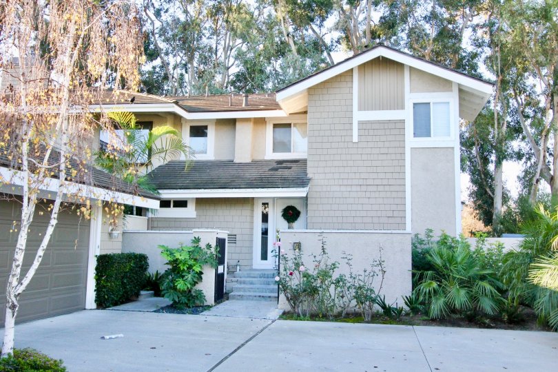 THE FRONT VIEW OF HOME WITH PLANTS AND TREES ARE LOCATED IN THE CITY OF IRVINE
