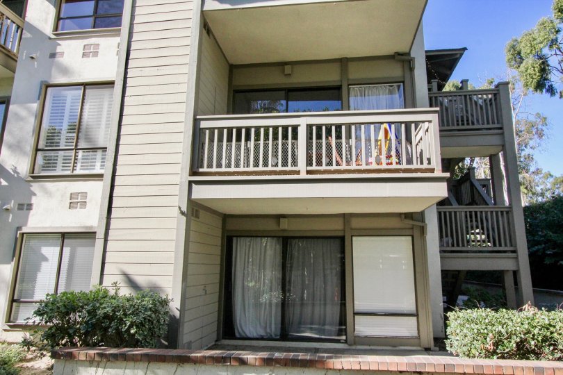 The long Rancho San Joaquin Townhomes building with balcony in front portion