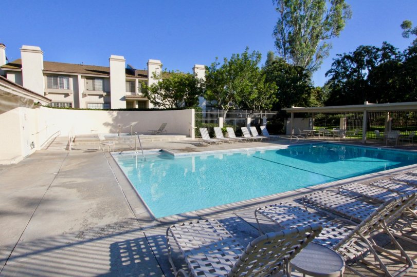 In Ridge Townhomes Bren, Swimming pool has seating chairs with dinning tables