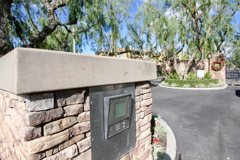 A stone-clad pillar in the Sheridan Place community with an embedded meter.