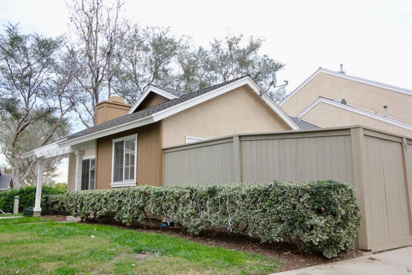 A surban home with a beige fence on a cloudy day in the community of Somerset within Irving, California