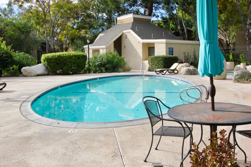 A large round pool in front of a shower area inside The Lakes in Irvine CA