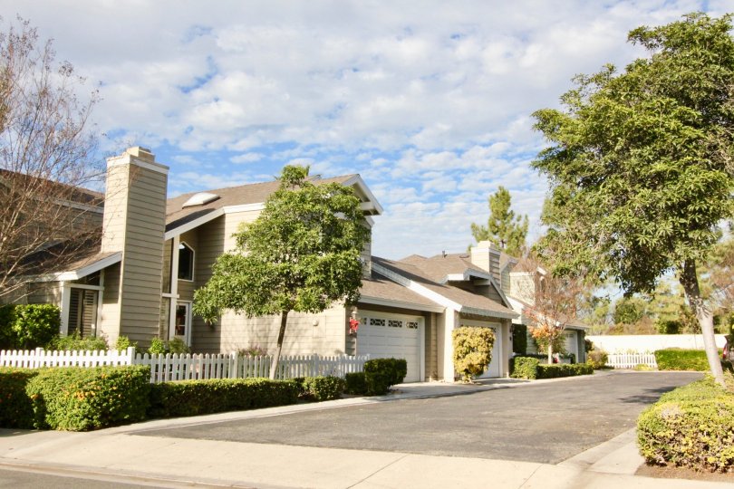 Driveway leading past garages attached to town homes at Windwood Garden Homes in Irvine CA