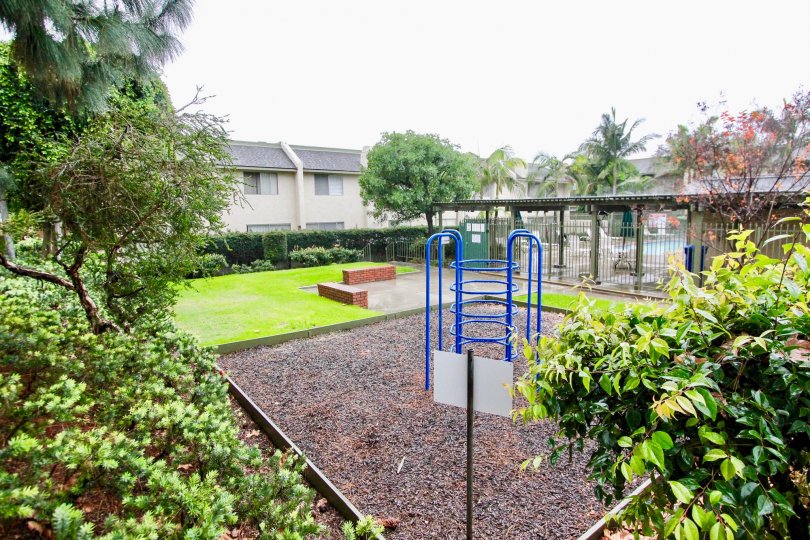 The garden in the heritage village is full of green plants and children's play ground with picnic shed