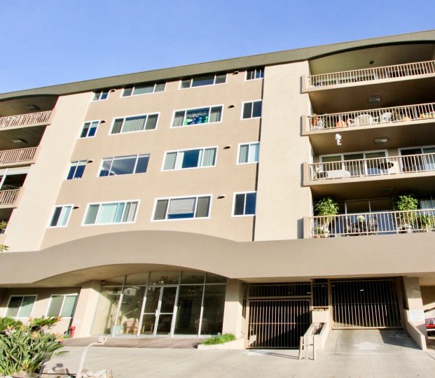 a warm day in the newport bay towers with building that has 4 storey and steel doors