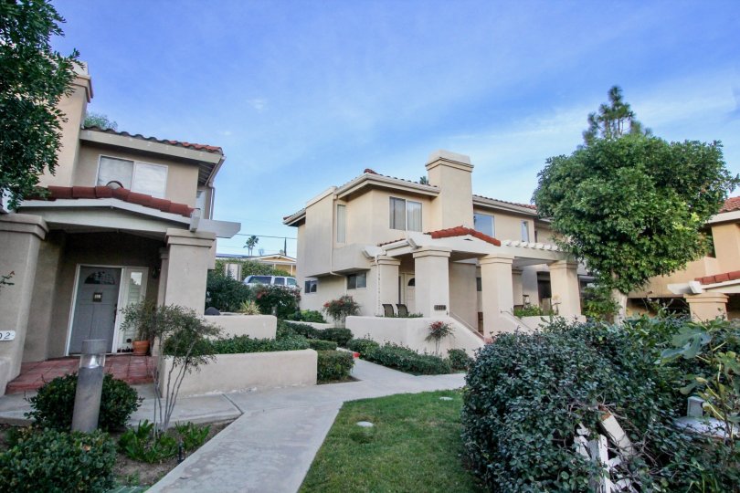 Beige two story condos with attached fireplaces lined with sidewalks in Villa Heights in Orange CA