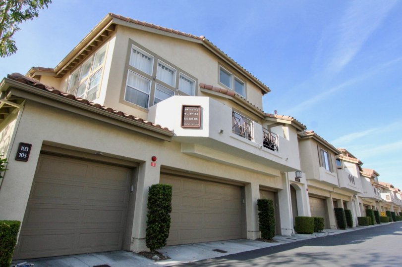 Several tan homes with garages in Cabo Vista community in Rancho Santa Margarita, California.