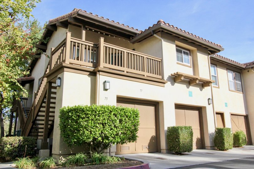 A tan and brown homes with garages in Los Portillos community in Rancho Santa Margarita, California.