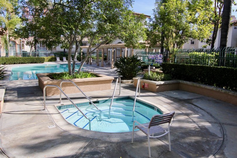 Fabulous looking dual swimming pools near villas with trees in Tierra Montanosa of Rancho Santa Margarita