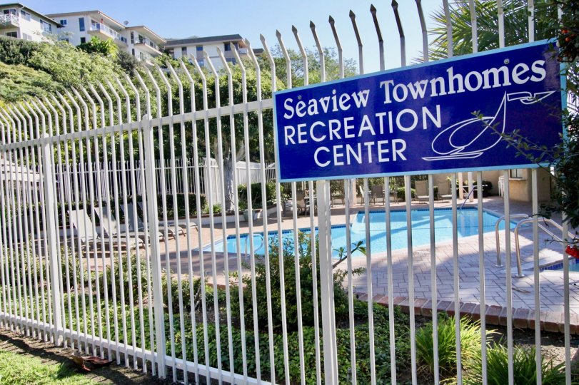 THE BUILDING WITH THE SEAVIEW TOWNHOMES WITH THE SWIMMING POOL, PLANTS, TREES
