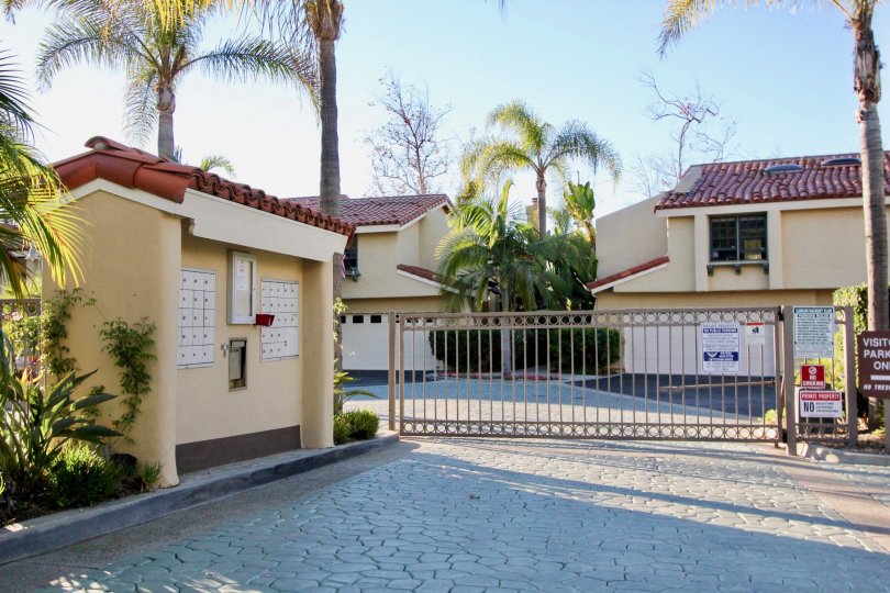 A Villa with main gate and palm treesof Cancun Racquet Club of San Juan Capistrano
