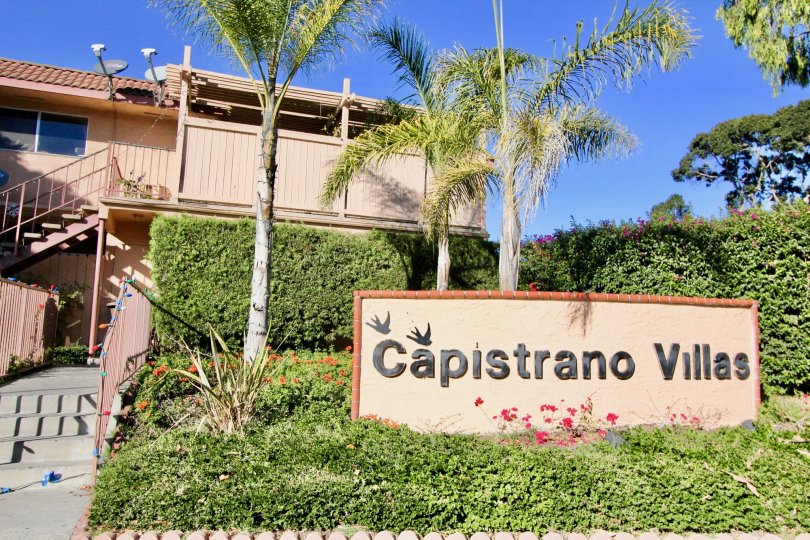 The sign infroming visitors in the grass reads Capristrano Villas