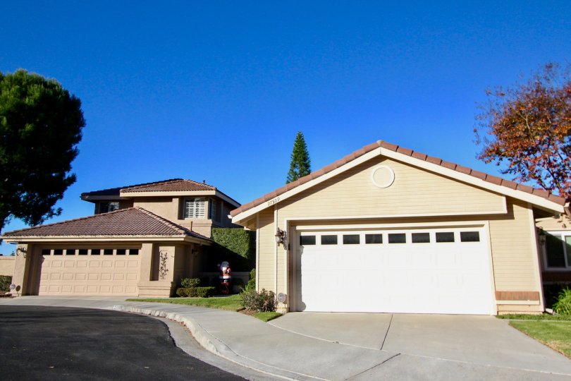 A two-storey residence with beige paint and closed carport in the Loma Vista community.