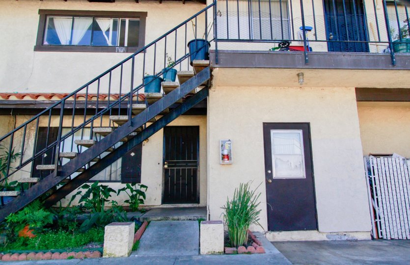 A bright day in the Corsican Village in front of a door and staircase.