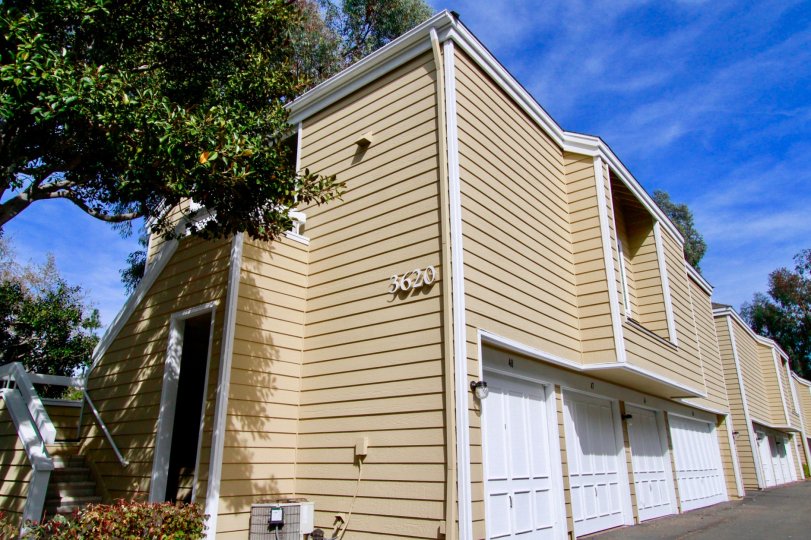 Side view of a large house with wide white color garage doors inside South coast springs community