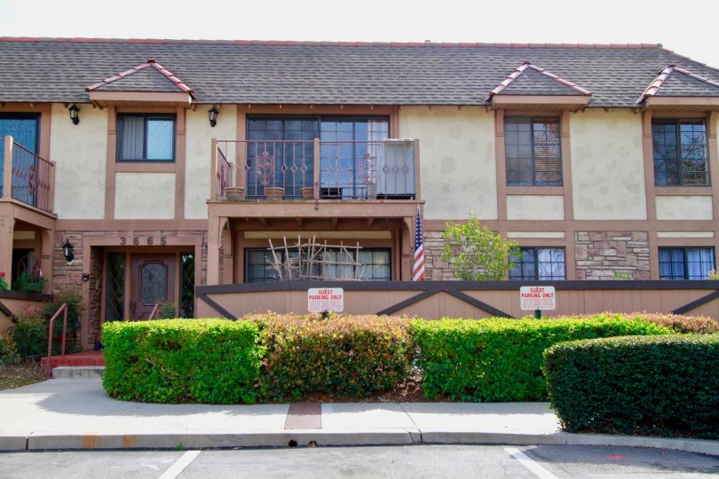 A huge house with a central balcony overlooking the garden inside the St. Albans community
