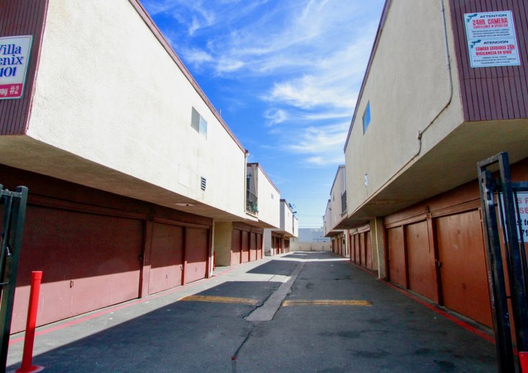 A clear day in the Villa Fenix with a path between buildings.
