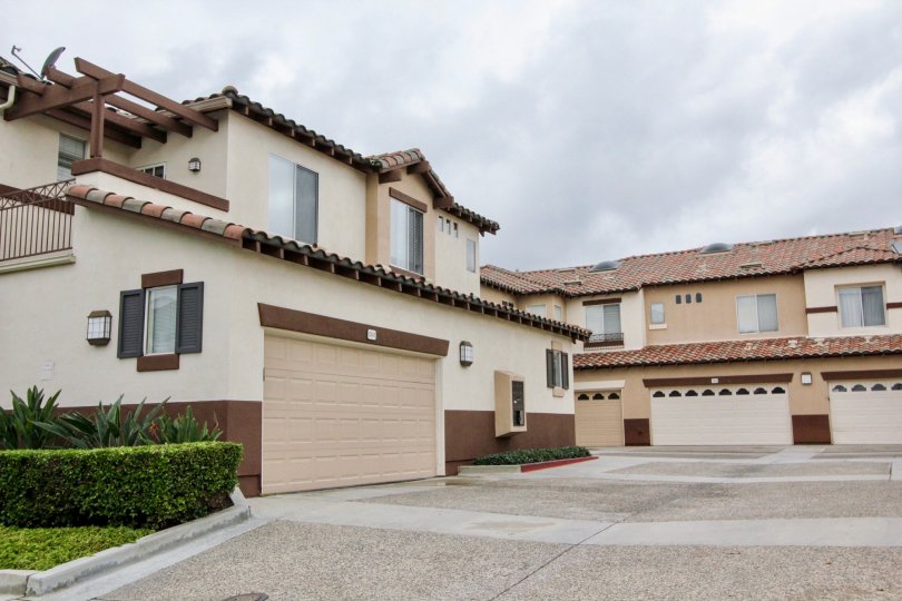 Nice view of villas on a cloudy day with garden and parking in Orchards of Tustin