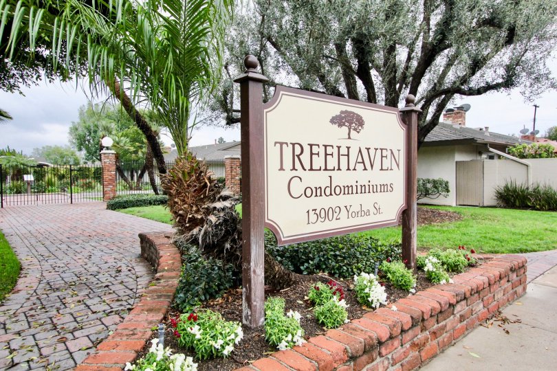 Condominiums with fences, gated, brick roads and walkways, under tree cover in Treehaven.