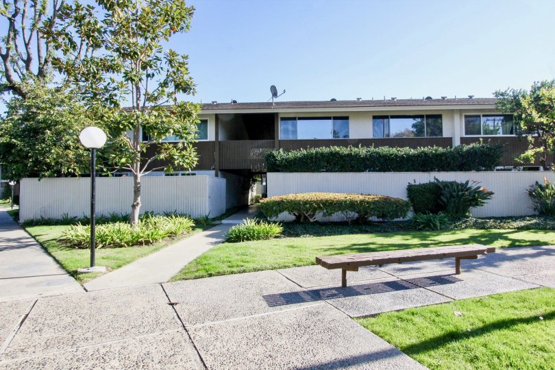 THE HOME IN THE TUSTIN VILLAGE WITH THE BULP, DISH ANTENNA, BENCH, LAWN