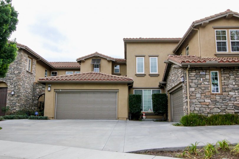 tan home with brick garage in canterbury community in yorba linda, california.