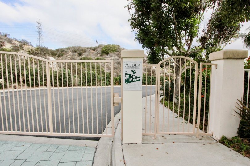 A driveway with cream gate in the Aldea neighborhood.