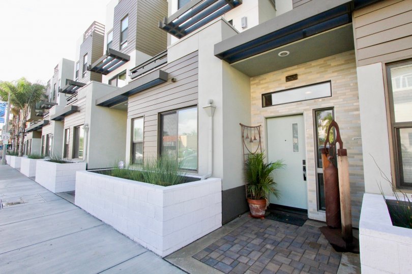 A two-storey contemporary townhouse with a wooden sculpture in the Seagrove community.