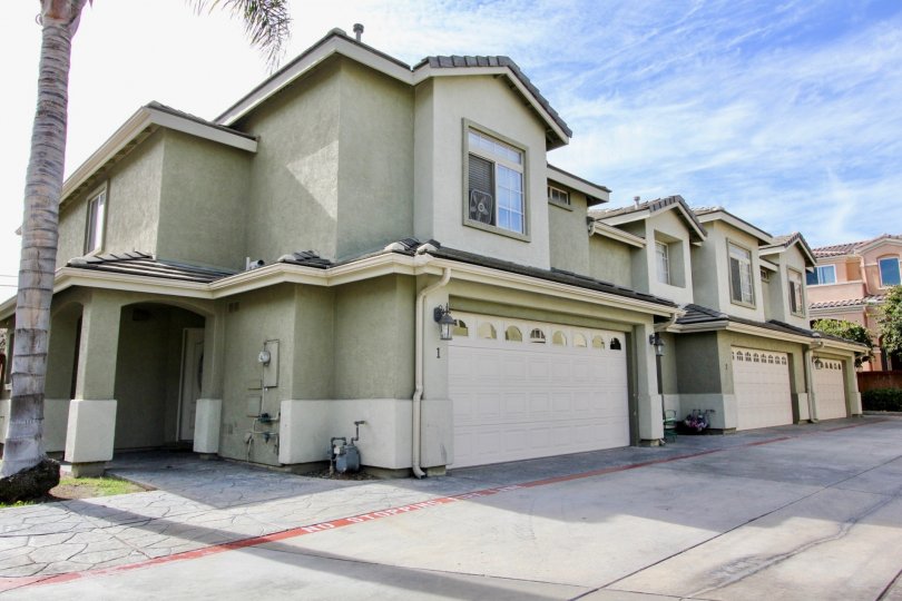 Contemporary styled attached homes with double car garages and flagstone lined walkways in Ada Terrace
