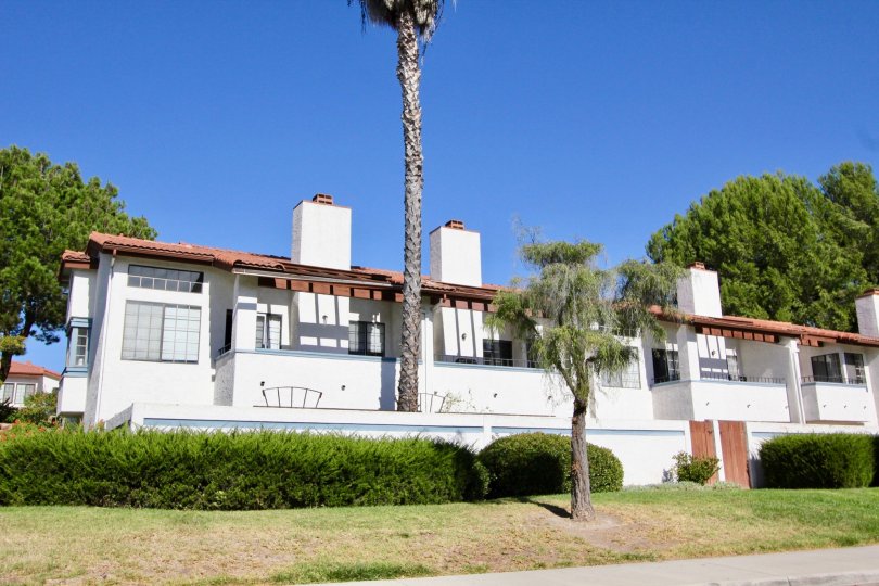 White chimneys rise from a two story residential building in Charter Point concos