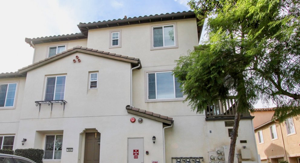 A three story white town home building inside Mar Brisa located at Chula Vista CA