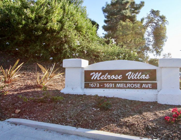 a sign of Melrose Villas welcoming people right in with trees and greenery all around