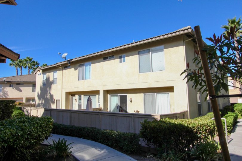 A simple two-storey residence in Via Capri community with a low fence and sliding windows.
