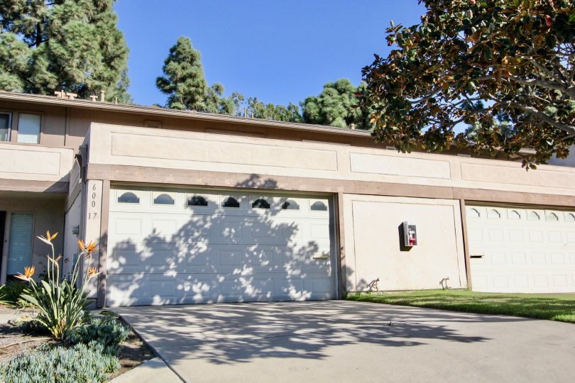 This shows the enter of the house way aside the plants are there, and trees, lawn also there and have the lot number there in the community of Windsor Heights