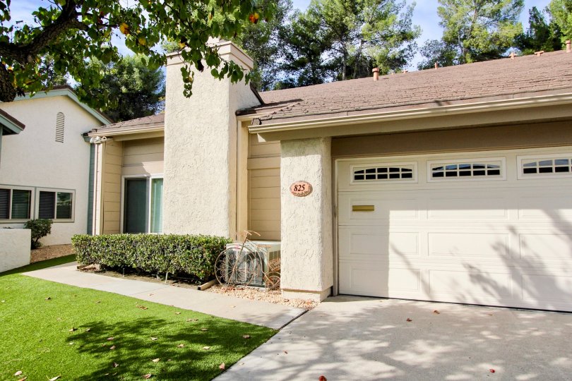The exterior of a Winsory View home showing the garage chimney and number 825