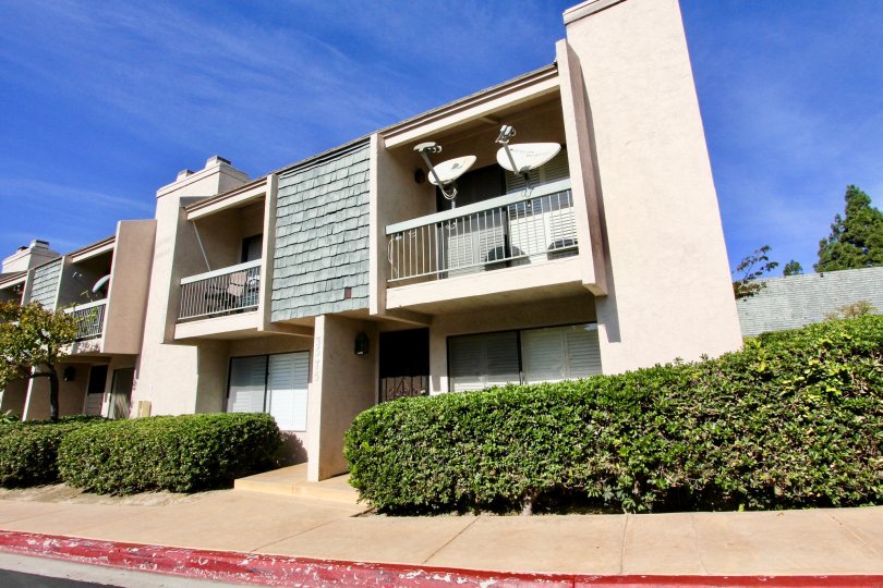 2 satellite dishes are attached to the railing on the balcony at the Pacific Racquet Club community in Clairemont Mesa California.