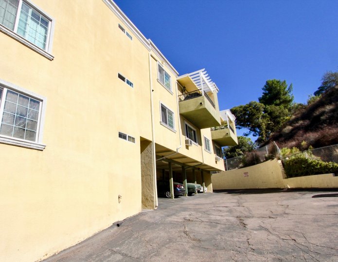 Beige outside view of balconies and parking of Collwood Point in College Area, California