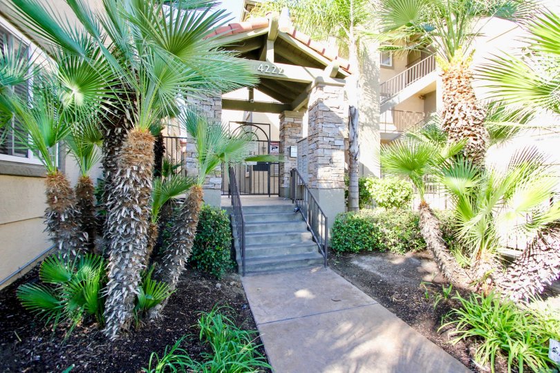 Outside covered entrance flanked by landscaping features at Menlo VVillage