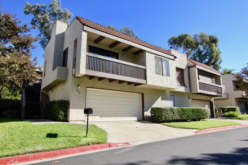 Front garage door and entrance of Montezuma Townhomes in College Area California on a sunny day