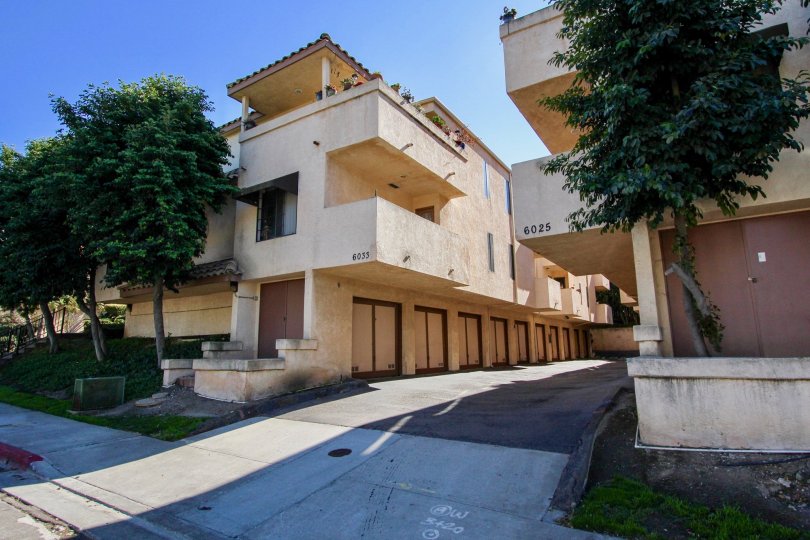 Three story residential buildings with attached garages at Villa Estelle West in College Area California