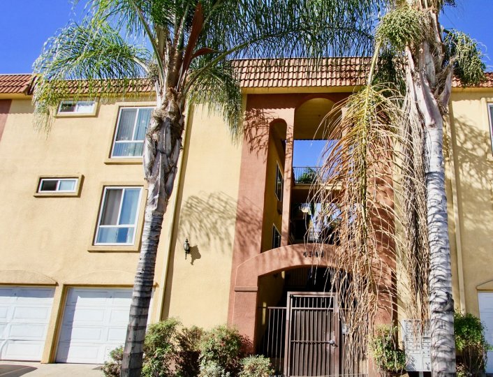 Light brown units with garages and a gate in Villa Toscana of College Area, California